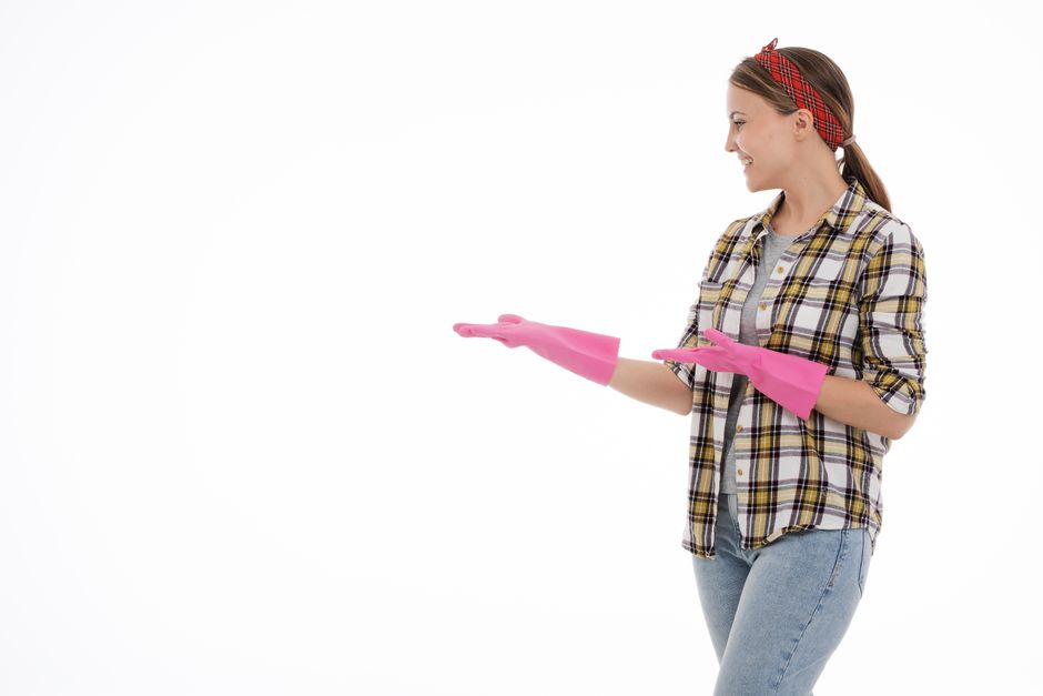 Professional cleaner smiling while assessing a carpet